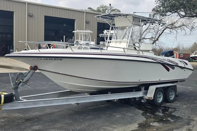 Slide: The Image of 1998 Fountain 25 Center Console boat on trailer outside a warehouse. - 7
