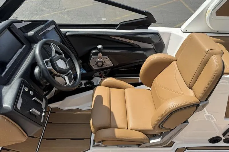 Slide: The Image of 2024 Supra SE 575 boat interior with tan leather seat and modern dashboard. - 10