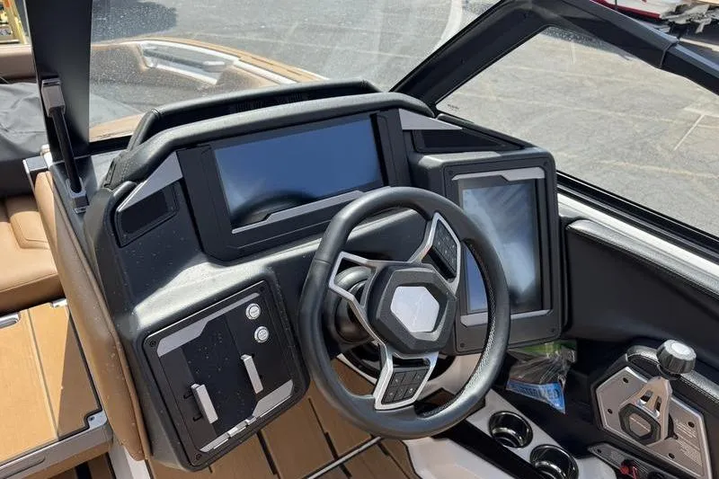 Slide: The Image of 2024 Supra SE 575 boat dashboard with modern steering and digital displays. - 5
