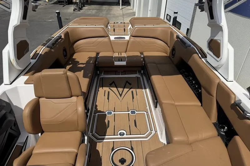 Slide: The Image of Luxurious interior of 2024 Supra SE 575 boat with tan leather seating and sleek design. - 6