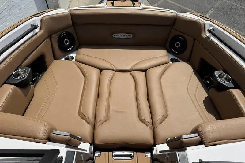Slide: The Image of 2024 Supra SE 575 boat interior with tan leather seating and built-in speakers. - 7