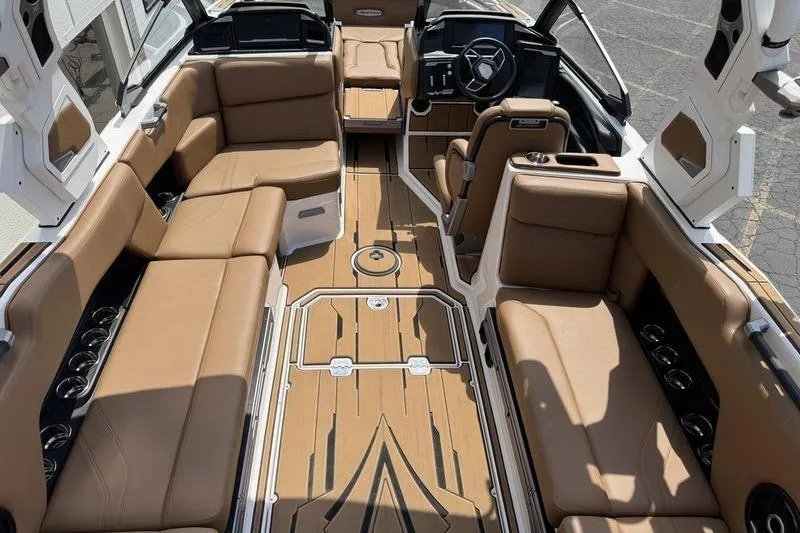 Slide: The Image of 2024 Supra SE 575 boat interior with luxurious brown seating and modern dashboard. - 8