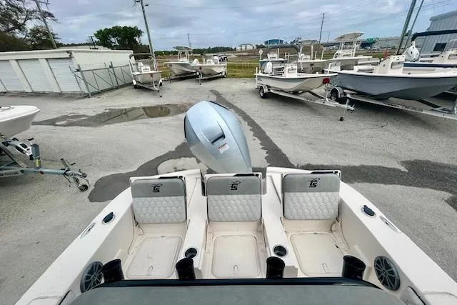 Slide: The Image of 2026 Carolina Skiff 22 Ultra Elite boat with outboard motor in a marina setting. - 11