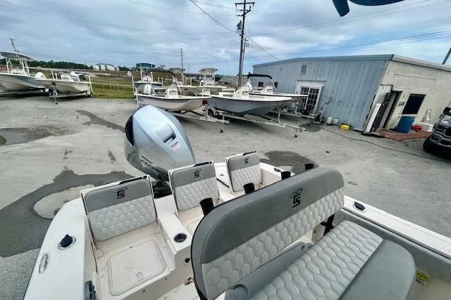 Slide: The Image of 2026 Carolina Skiff 22 Ultra Elite boat with seating, parked at a marina. - 13