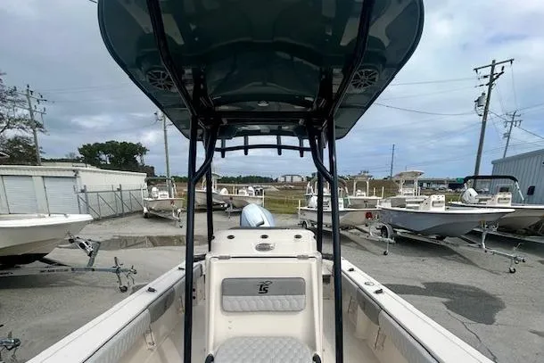 Slide: The Image of 2026 Carolina Skiff 22 Ultra Elite boat in a marina, surrounded by other boats. - 5