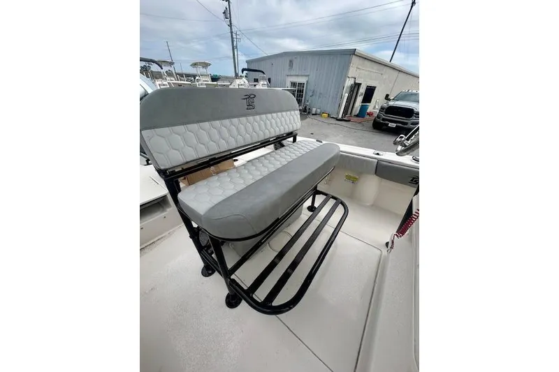 Slide: The Image of 2026 Carolina Skiff 22 Ultra Elite boat seat with gray upholstery and black frame. - 7