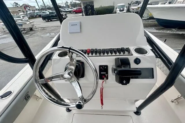 Slide: The Image of 2026 Carolina Skiff 22 Ultra Elite boat console with steering wheel and controls. - 9