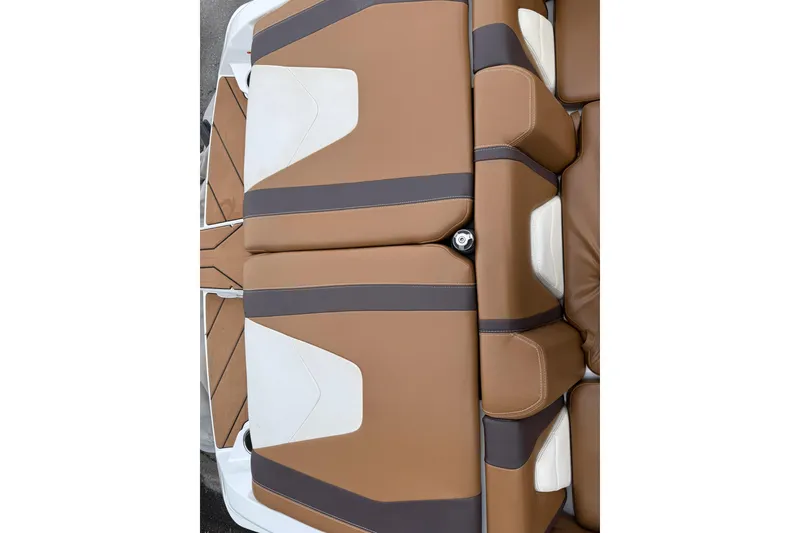 Slide: The Image of 2020 Malibu Wakesetter 21 VLX boat interior with brown and white seating. - 14
