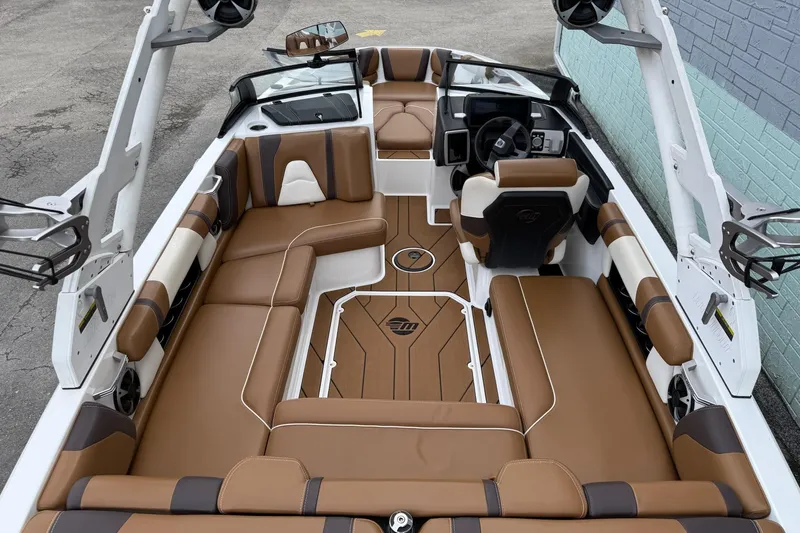 Slide: The Image of 2020 Malibu Wakesetter 21 VLX interior with brown and white seating, modern dashboard. - 15