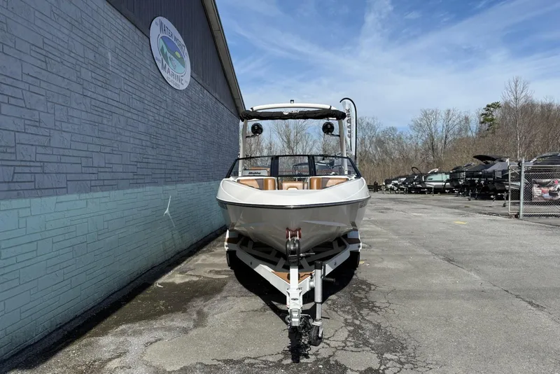 Slide: The Image of 2020 Malibu Wakesetter 21 VLX boat on trailer, parked outside marine dealership. - 4