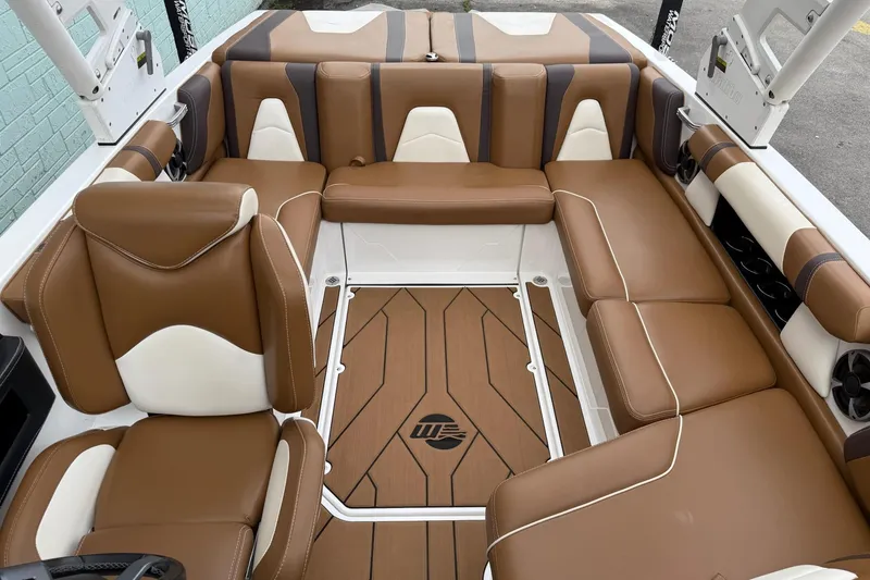 Slide: The Image of 2020 Malibu Wakesetter 21 VLX interior with brown and white seating, stylish design. - 9