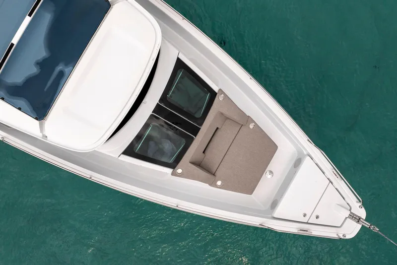 Slide: The Image of Top view of 2025 Axopar 45 Cross Top boat on turquoise water. - 17