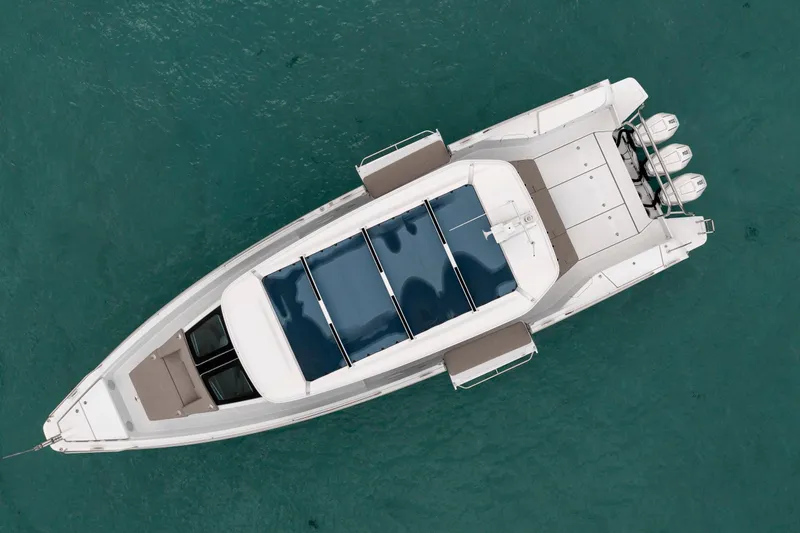 Slide: The Image of Top view of 2025 Axopar 45 Cross Top boat on clear blue water. - 2
