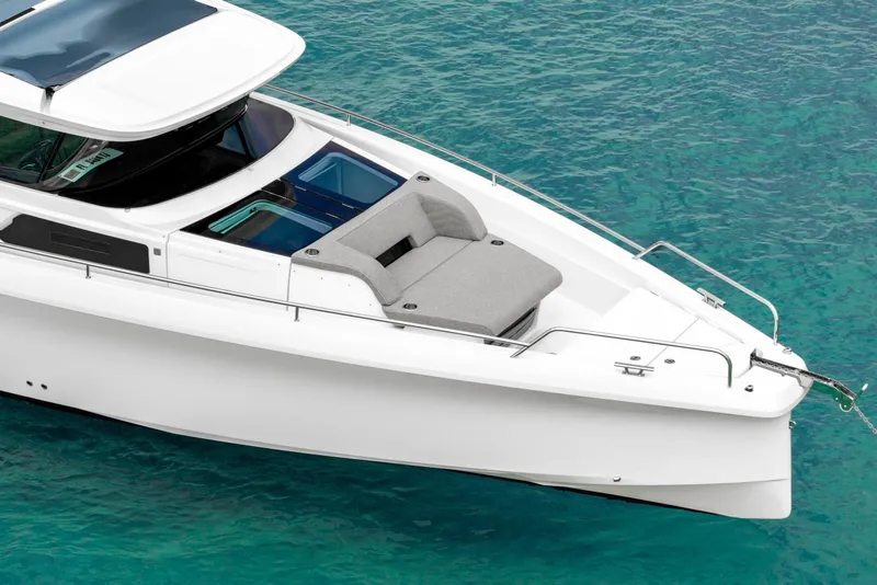 Slide: The Image of 2025 Axopar 45 Cross Top boat on clear turquoise water. - 20