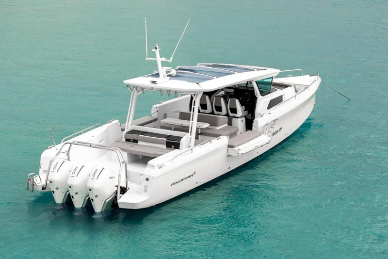 Slide: The Image of 2025 Axopar 45 Cross Top boat on clear turquoise water. - 22