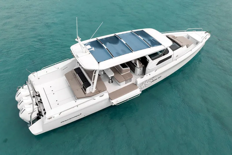 Slide: The Image of 2025 Axopar 45 Cross Top boat on clear turquoise water. - 24