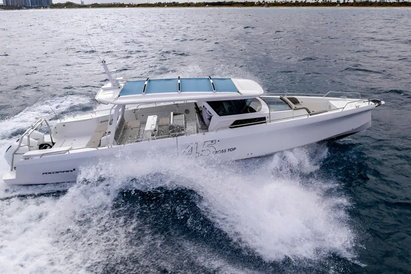 Slide: The Image of 2025 Axopar 45 Cross Top cruising on open water, showcasing sleek design and performance. - 28