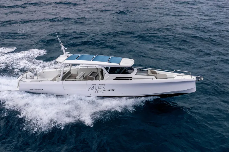 Slide: The Image of 2025 Axopar 45 Cross Top cruising on open water. - 33