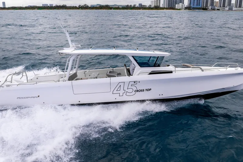 Slide: The Image of 2025 Axopar 45 Cross Top cruising on open water, showcasing sleek design and performance. - 34