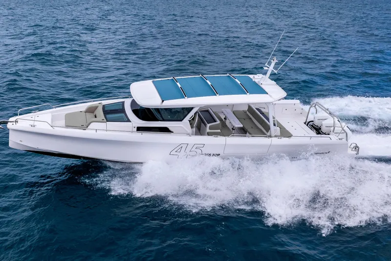 Slide: The Image of 2025 Axopar 45 Cross Top boat cruising on open water. - 36