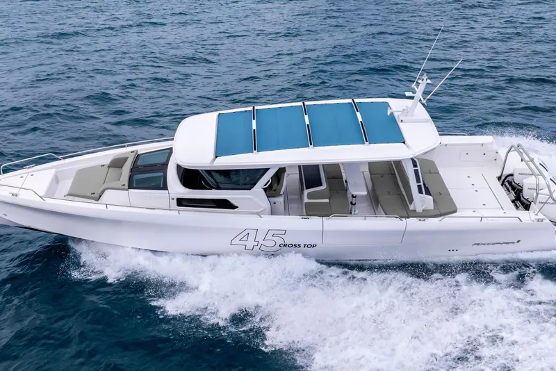 Slide: The Image of 2025 Axopar 45 Cross Top boat cruising on open water. - 37