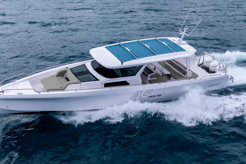 Slide: The Image of 2025 Axopar 45 Cross Top boat cruising on open water. - 38