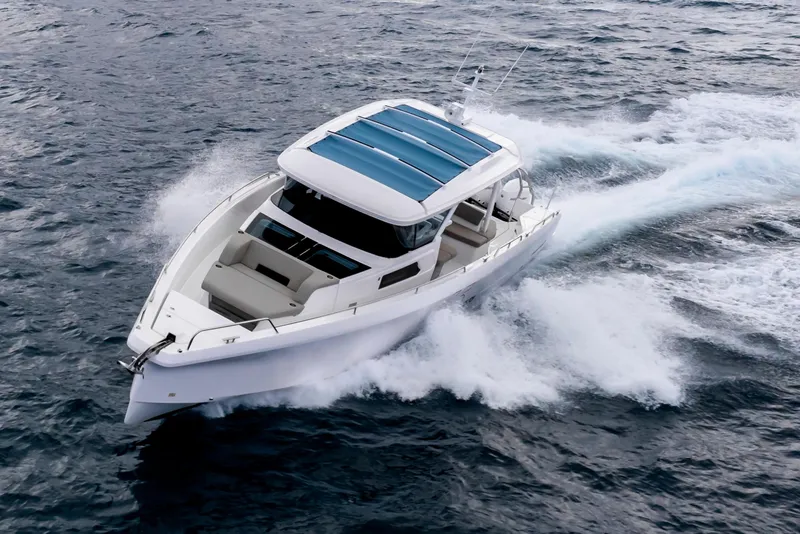 Slide: The Image of 2025 Axopar 45 Cross Top cruising on open water, showcasing sleek design and performance. - 41