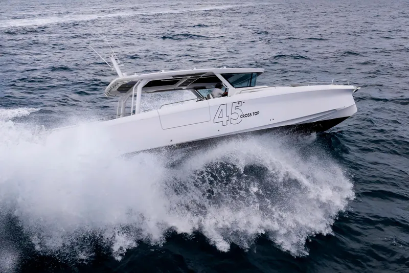 Slide: The Image of 2025 Axopar 45 Cross Top boat navigating through ocean waves. - 42