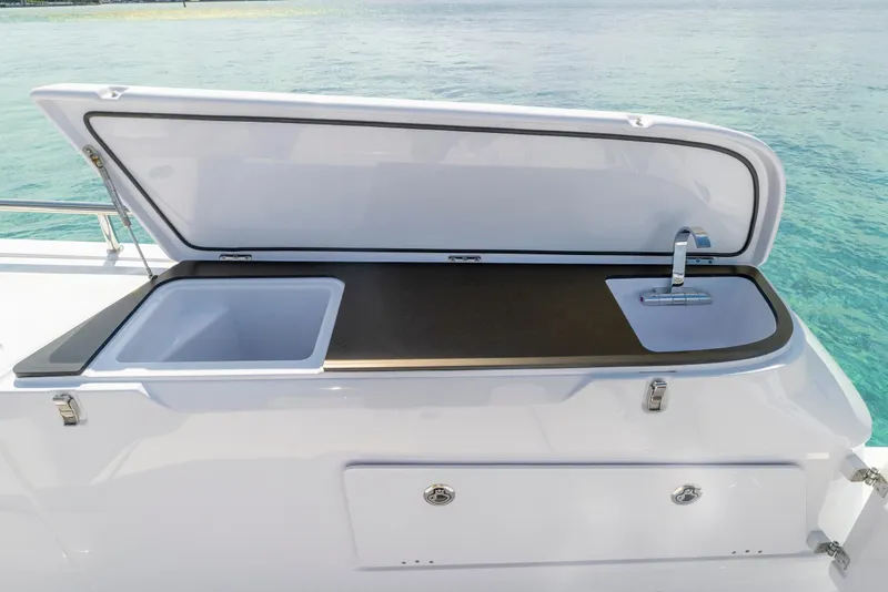 Slide: The Image of Outdoor sink and storage on 2025 Axopar 45 Cross Top boat, with ocean backdrop. - 45