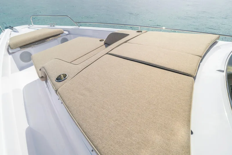 Slide: The Image of 2025 Axopar 45 Cross Top boat with spacious sunbathing deck and cup holders. - 48
