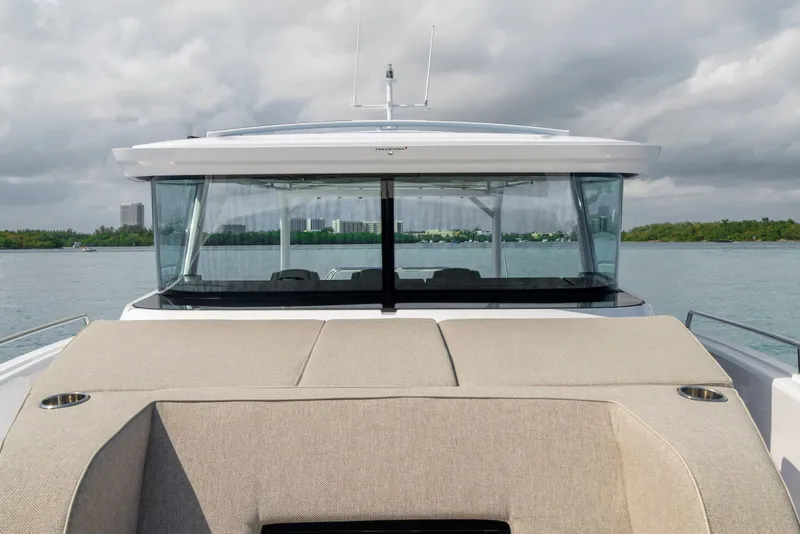 Slide: The Image of 2025 Axopar 45 Cross Top boat on water, featuring sleek design and modern amenities. - 50