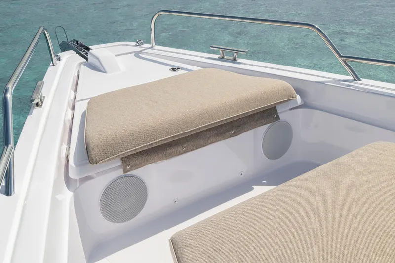 Slide: The Image of 2025 Axopar 45 Cross Top boat with beige seating and stainless steel railings. - 51