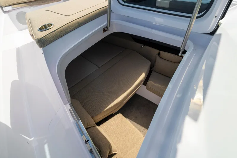 Slide: The Image of 2025 Axopar 45 Cross Top cabin interior with beige seating and modern design. - 54