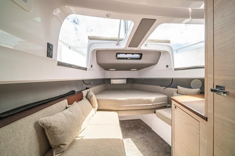 Slide: The Image of Interior of 2025 Axopar 45 Cross Top boat, featuring cozy seating and modern design. - 57