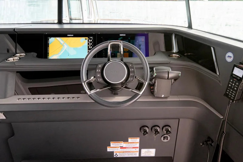 Slide: The Image of 2025 Axopar 45 Cross Top helm with modern navigation displays and controls. - 59