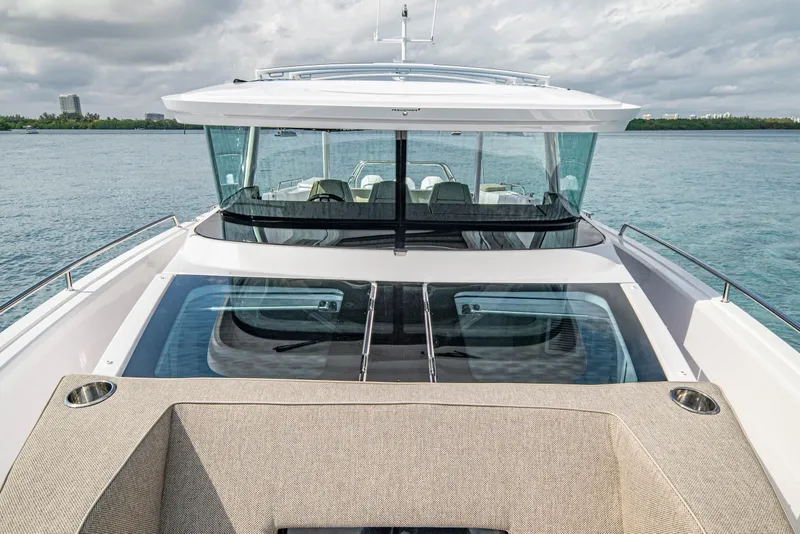 Slide: The Image of 2025 Axopar 45 Cross Top boat with sleek design on calm waters. - 60