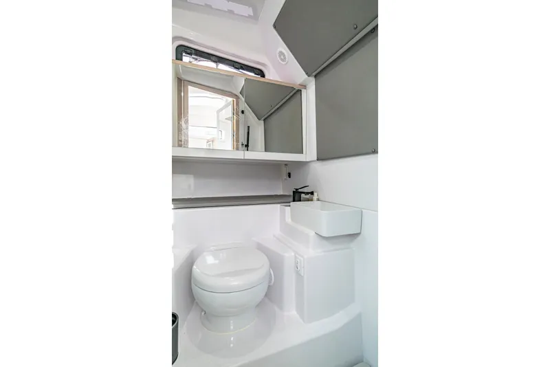 Slide: The Image of Modern bathroom interior of 2025 Axopar 45 Cross Top boat, featuring toilet and sink. - 61