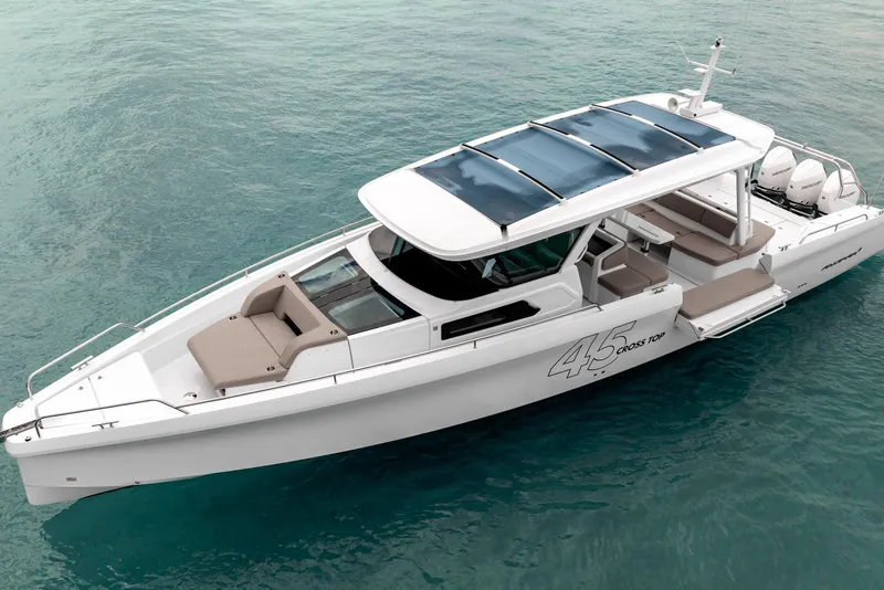 Slide: The Image of 2025 Axopar 45 Cross Top boat on clear blue water, showcasing sleek design and spacious deck. - 9
