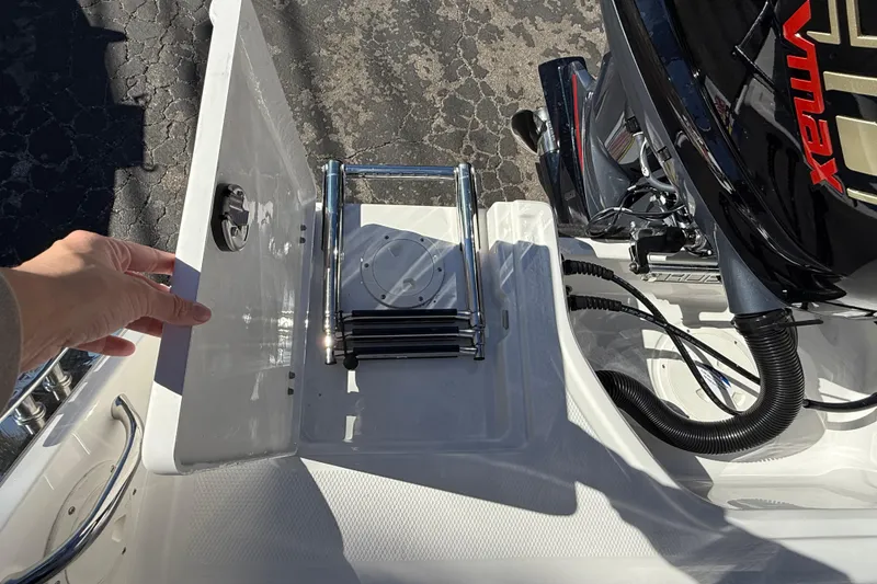 Slide: The Image of 2024 Robalo R230 Center Console boat with foldable ladder and engine detail. - 11