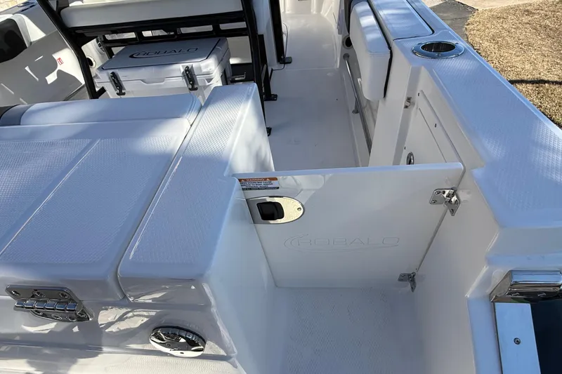 Slide: The Image of 2024 Robalo R230 Center Console boat interior with seating and storage features. - 12
