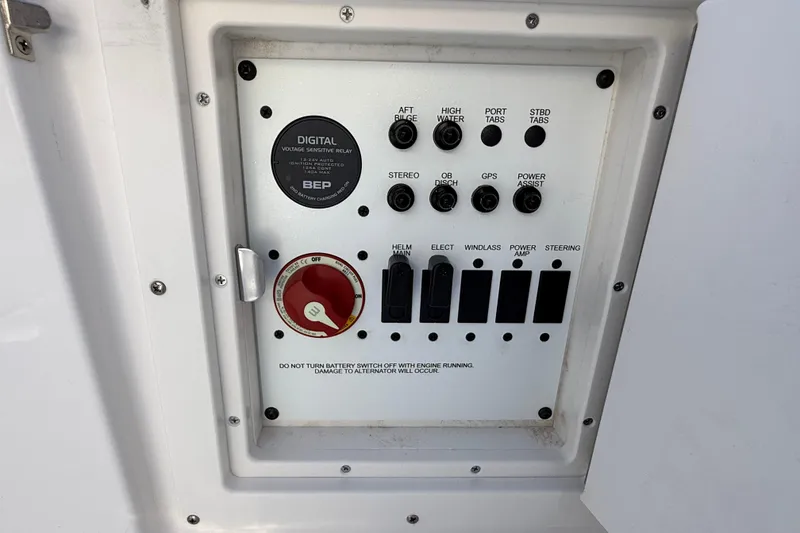 Slide: The Image of 2024 Robalo R230 Center Console control panel with switches and digital relay. - 14