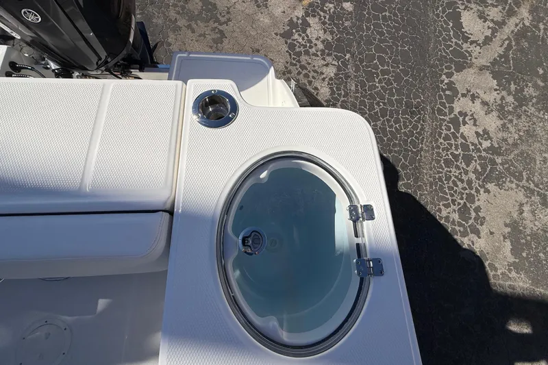 Slide: The Image of 2024 Robalo R230 Center Console boat with livewell and seating area. - 17