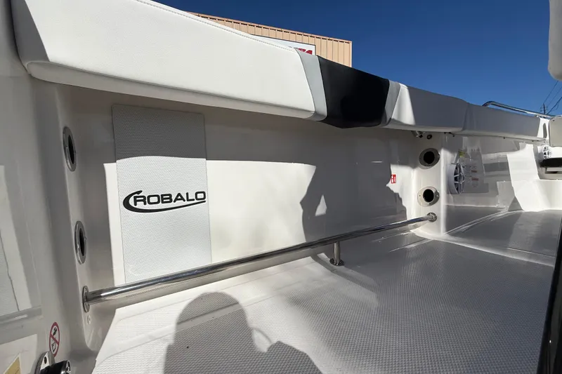 Slide: The Image of 2024 Robalo R230 Center Console boat interior with logo and stainless steel rail. - 19