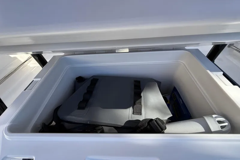 Slide: The Image of Storage compartment in 2024 Robalo R230 Center Console boat, featuring organized interior space. - 21