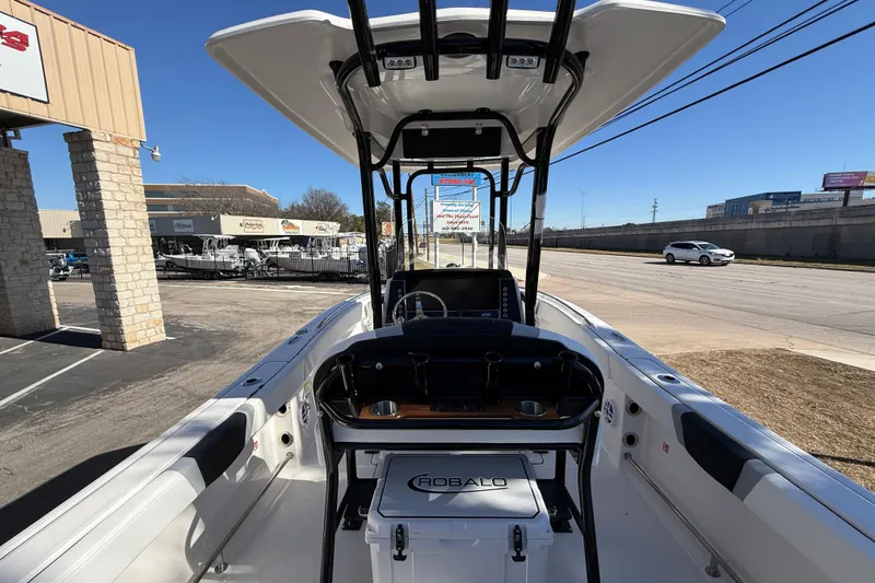 Slide: The Image of 2024 Robalo R230 Center Console boat displayed outdoors, showcasing sleek design and spacious interior. - 22