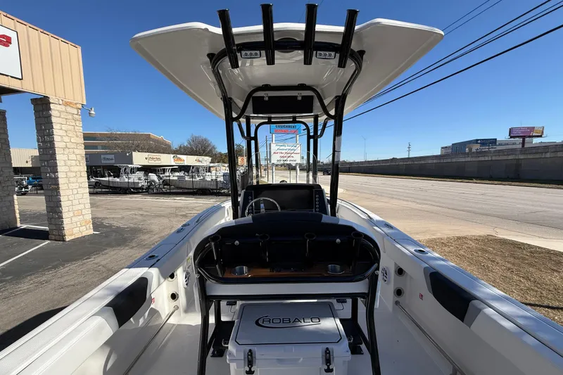 Slide: The Image of 2024 Robalo R230 Center Console boat displayed at dealership, showcasing interior and console features. - 23