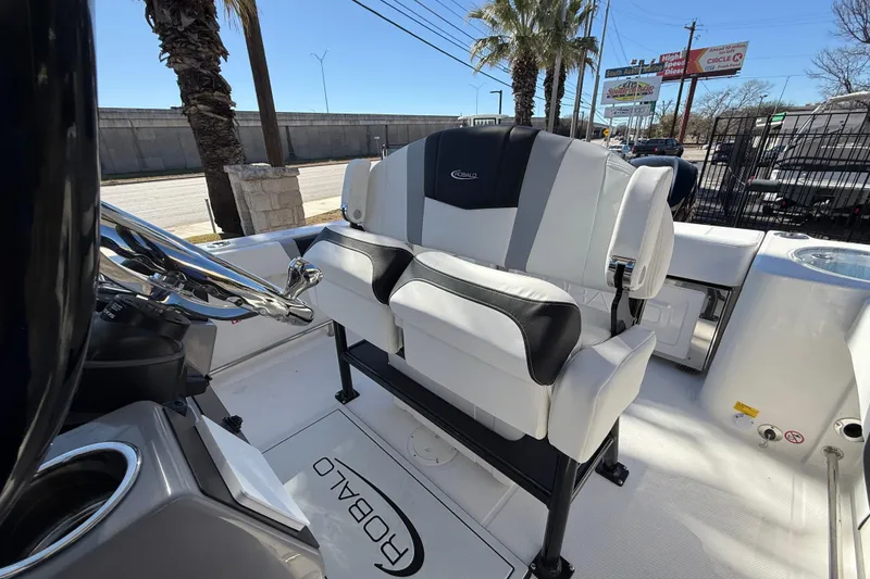 Slide: The Image of 2024 Robalo R230 Center Console boat interior with sleek seating and steering wheel. - 24