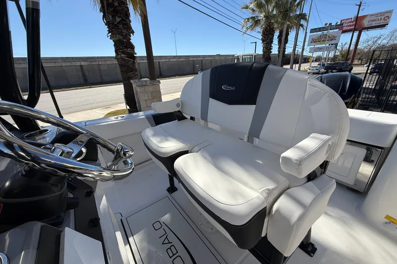 Slide: The Image of 2024 Robalo R230 Center Console boat interior with plush seating and steering wheel. - 26