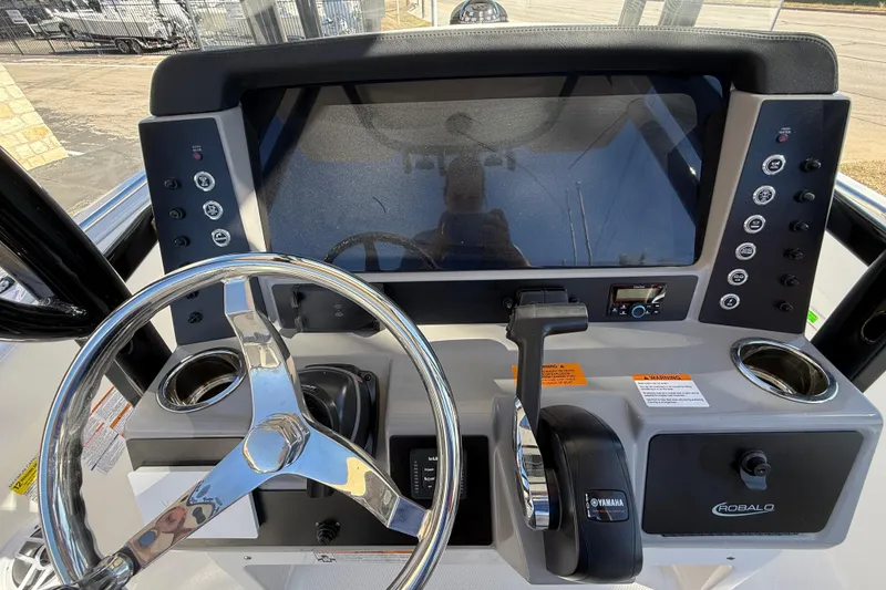 Slide: The Image of 2024 Robalo R230 Center Console dashboard with steering wheel and control panel. - 30
