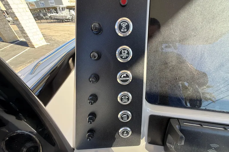 Slide: The Image of 2024 Robalo R230 Center Console dashboard with control buttons for various boat functions. - 31